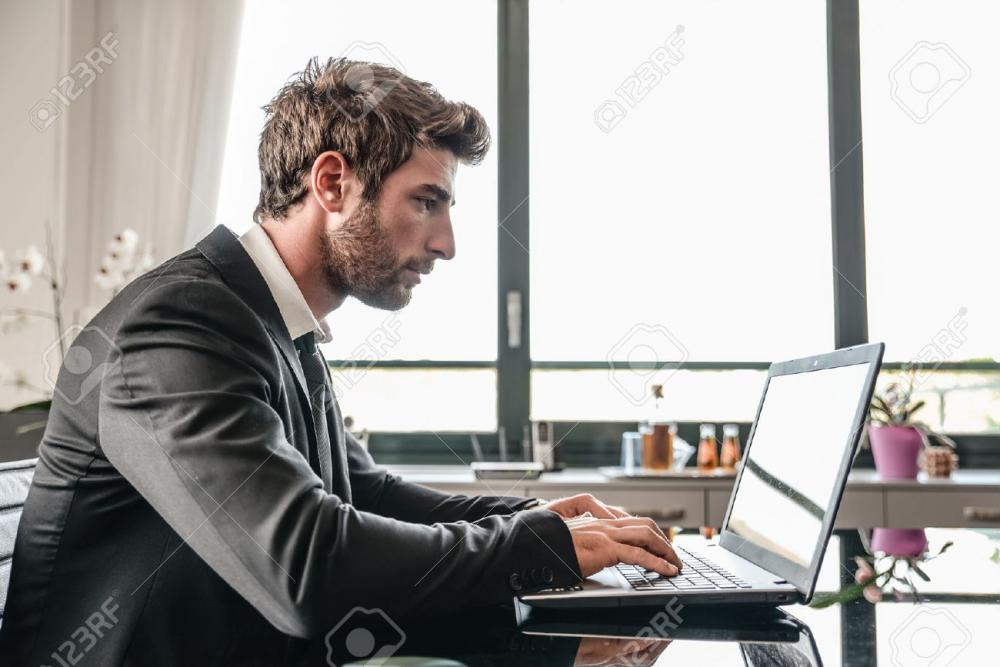 35664691-business-man-working-on-computer-desk-busy-office-worker-computing-on-lap-top.jpg